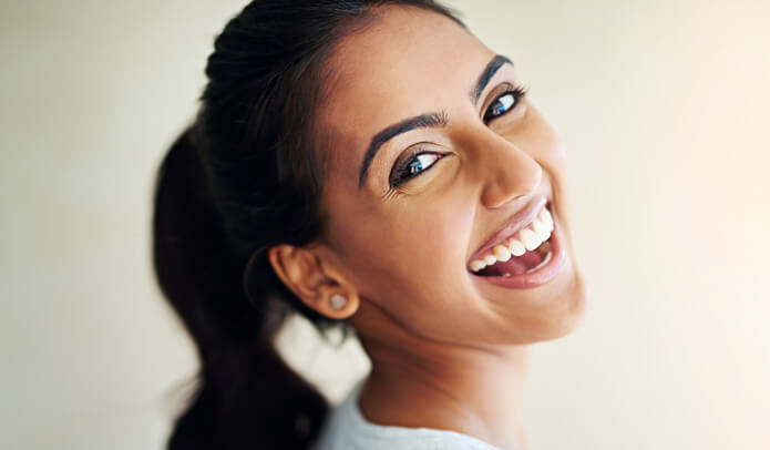 Woman with dental implants in Maidstone, Kent smiling back