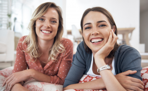 two friends smiling after receiving align, bleach, and bond