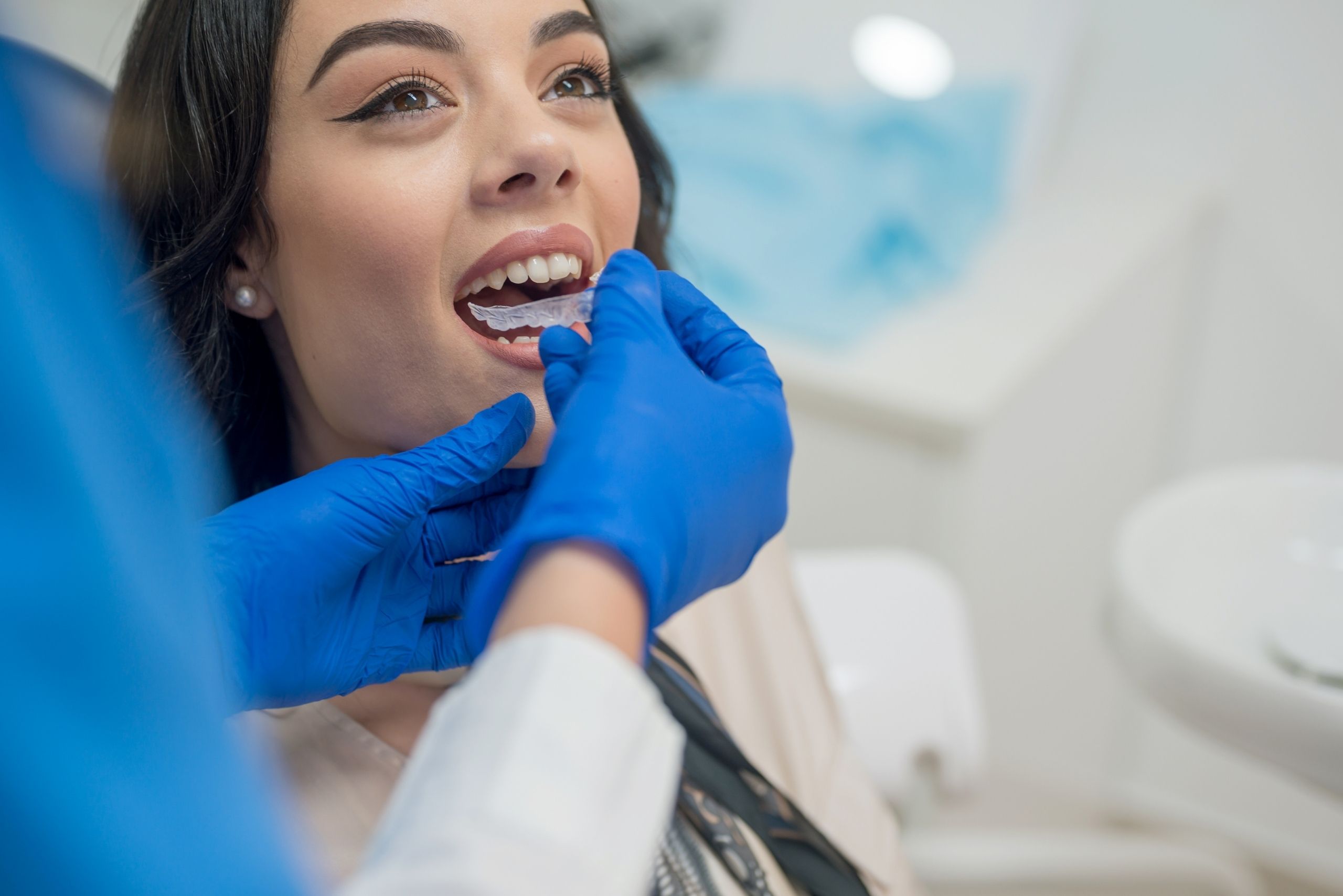 Woman sat at Maidstone dental practice receiving orthodontic treatment from dentists