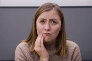 woman with cheek pain due to dental health