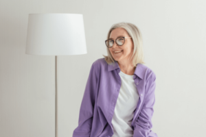 Woman with dental implants with purple shirt on at Maidstone dentist