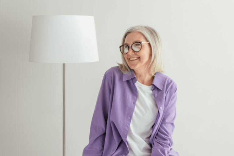 Woman with dental implants with purple shirt on at Maidstone dentist